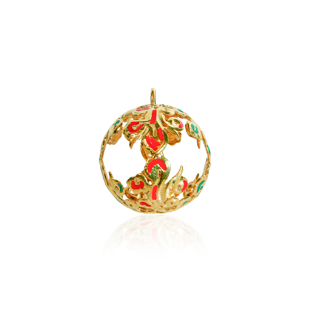 Gold pendant with red and green accents on a white background