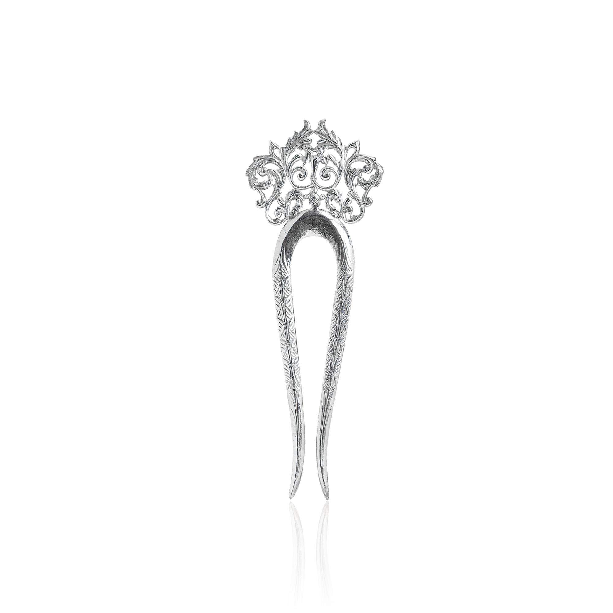 Silver hairpin with intricate design on a white background