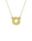 Gold necklace with a circular pendant on a white background