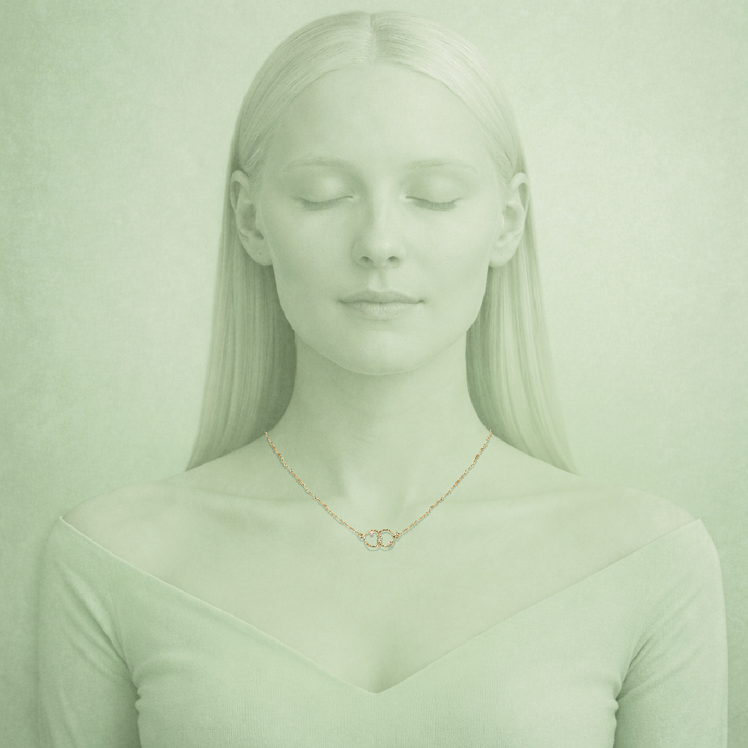 Woman wearing a gold necklace with a green tinted filter