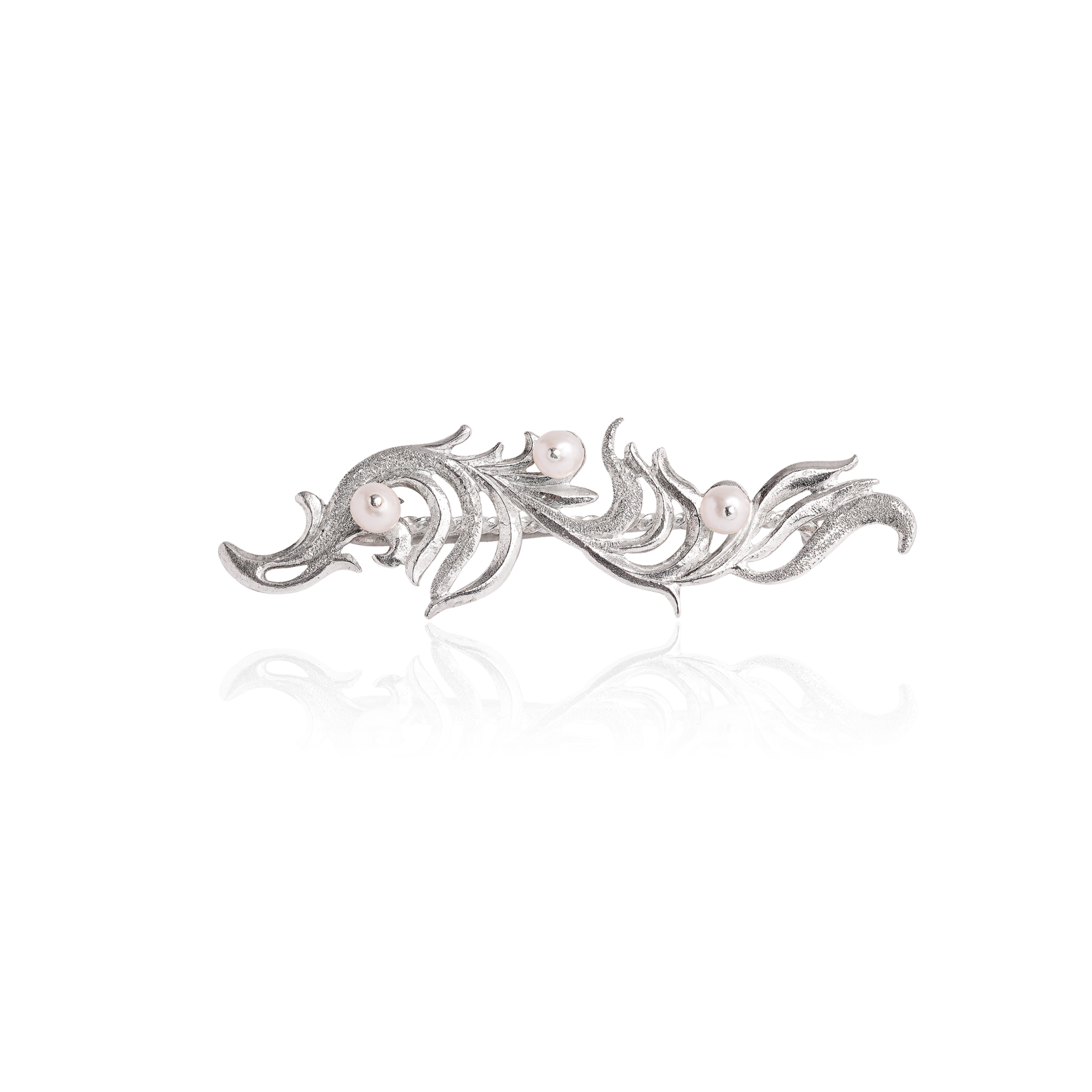 Sterling silver brooch featuring flowing botanical motifs and pearl accents in an elegant sculptural openwork design.