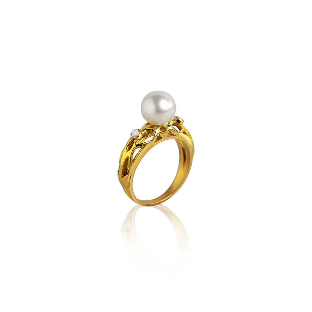 Gold ring with a pearl on a white background