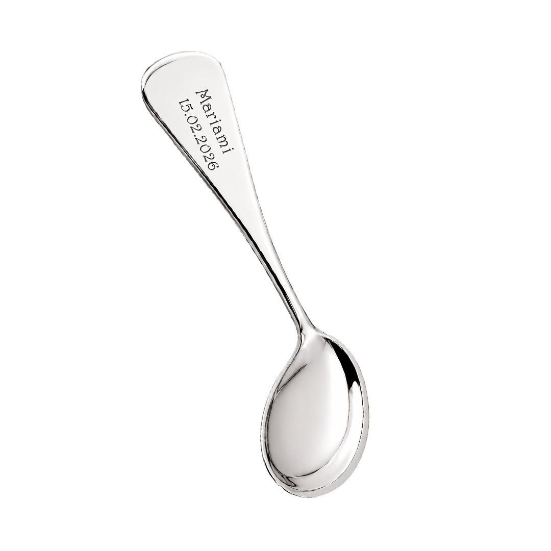 Silver spoon with engraved text on a white background