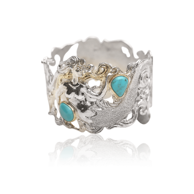 Silver ring with turquoise stones on a white background