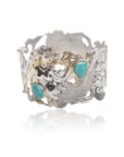 Silver ring with turquoise stones on a white background
