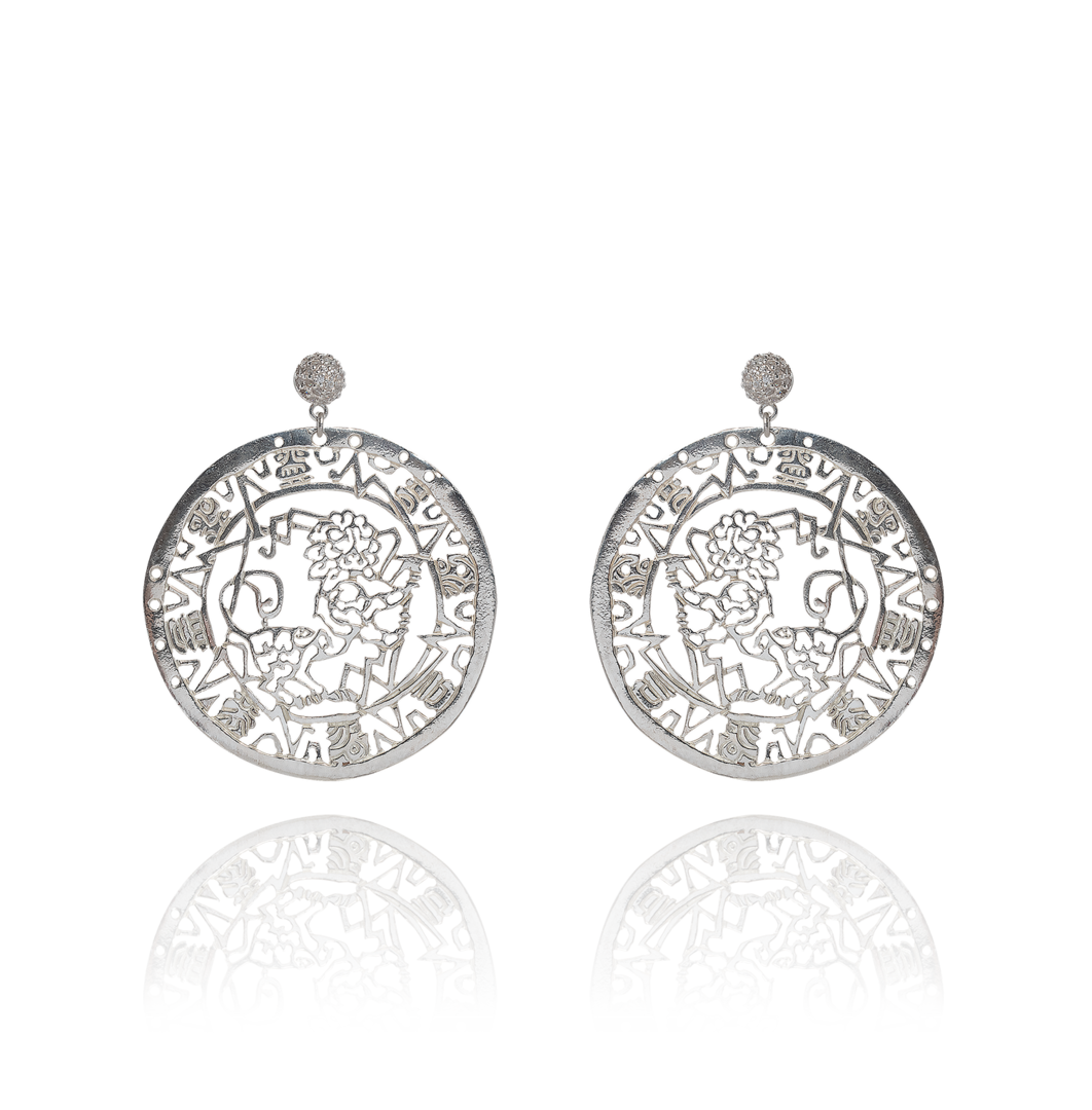 Pair of silver earrings with intricate designs on a white background