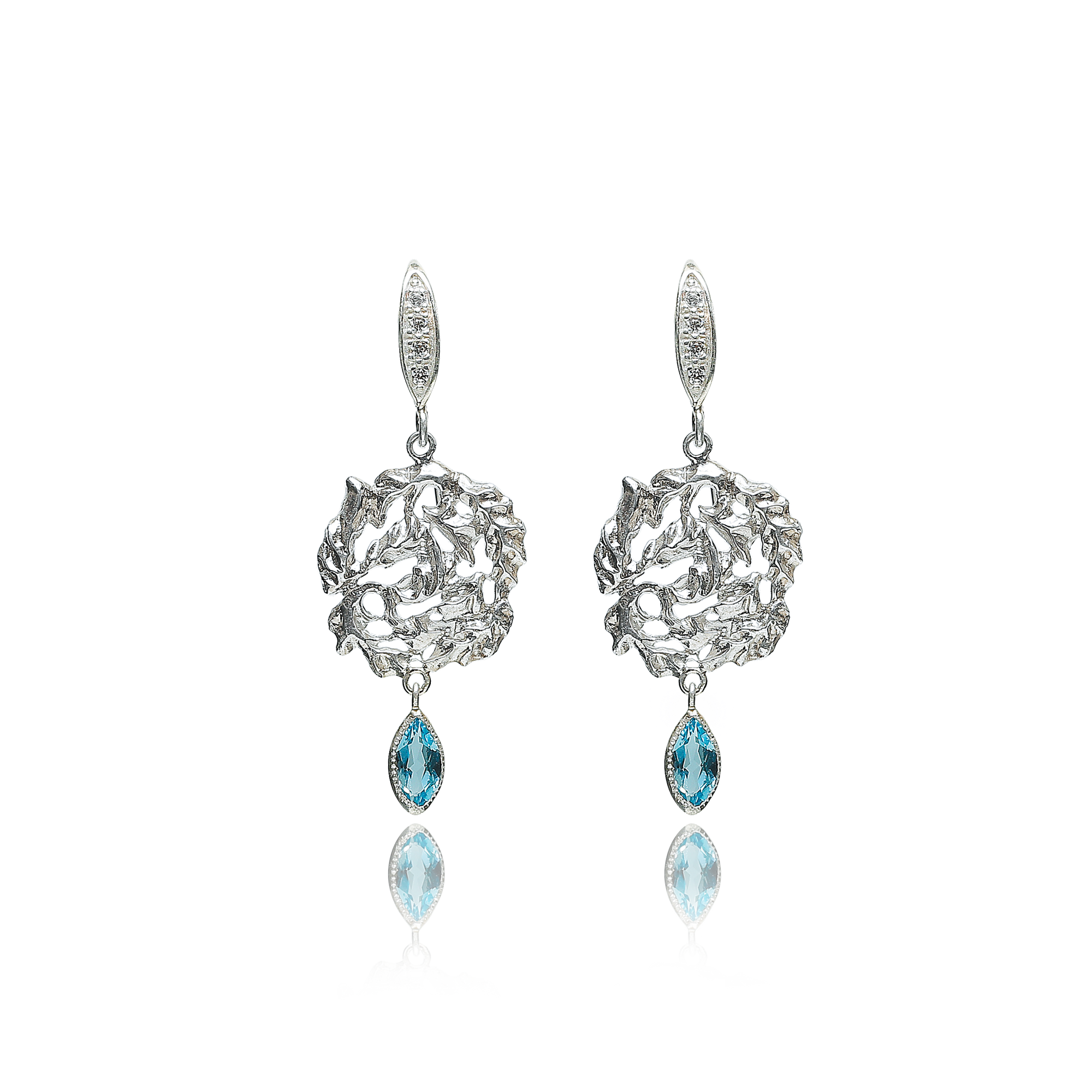 Silver earrings with blue gemstones on a white background