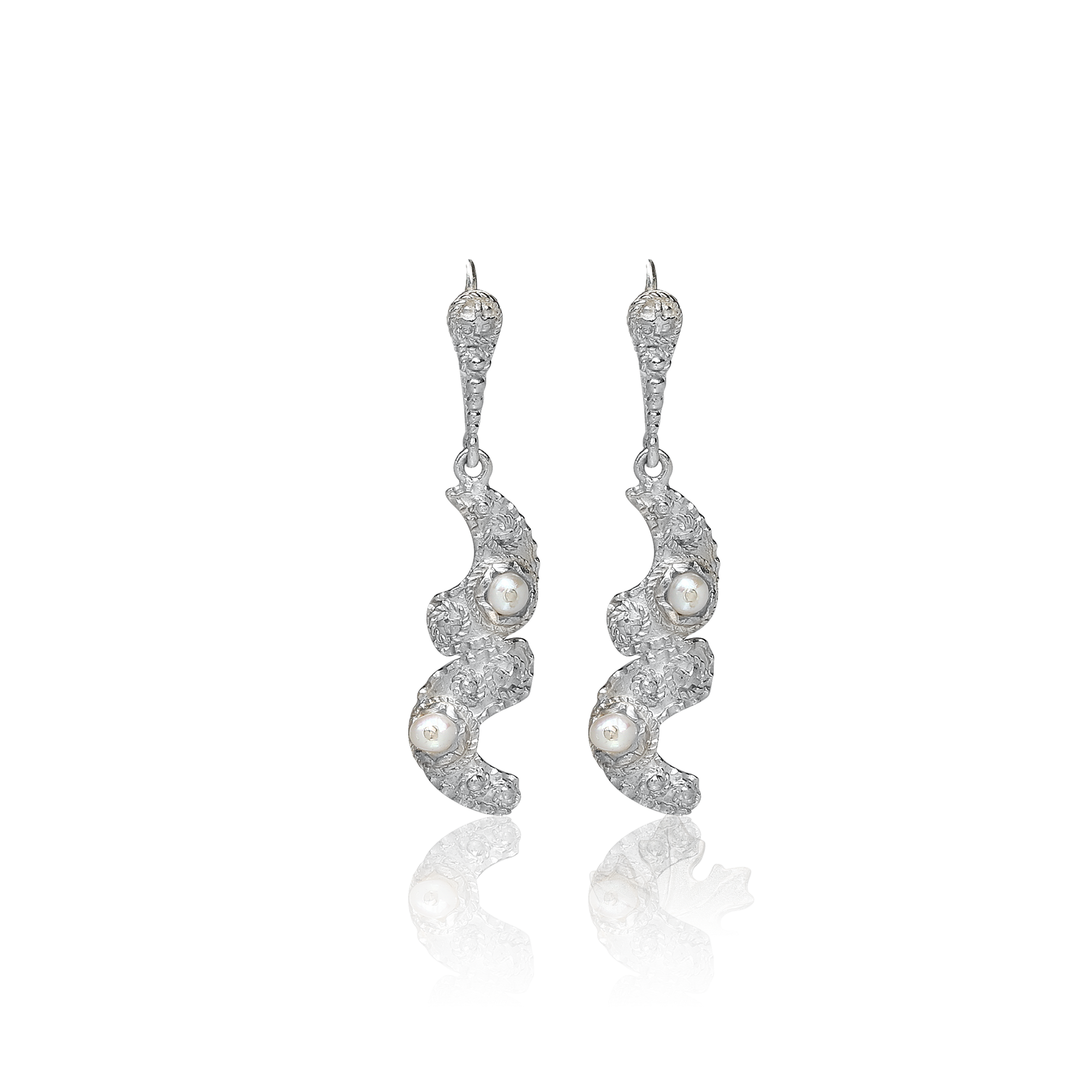 Silver earrings with pearls on a white background