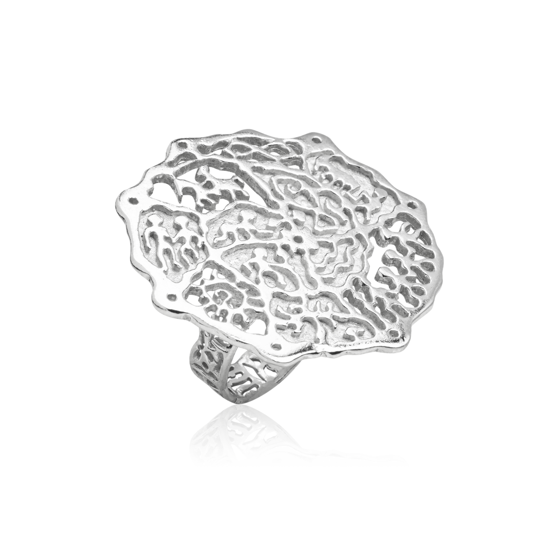 Silver ring with intricate lace-like design on a white background