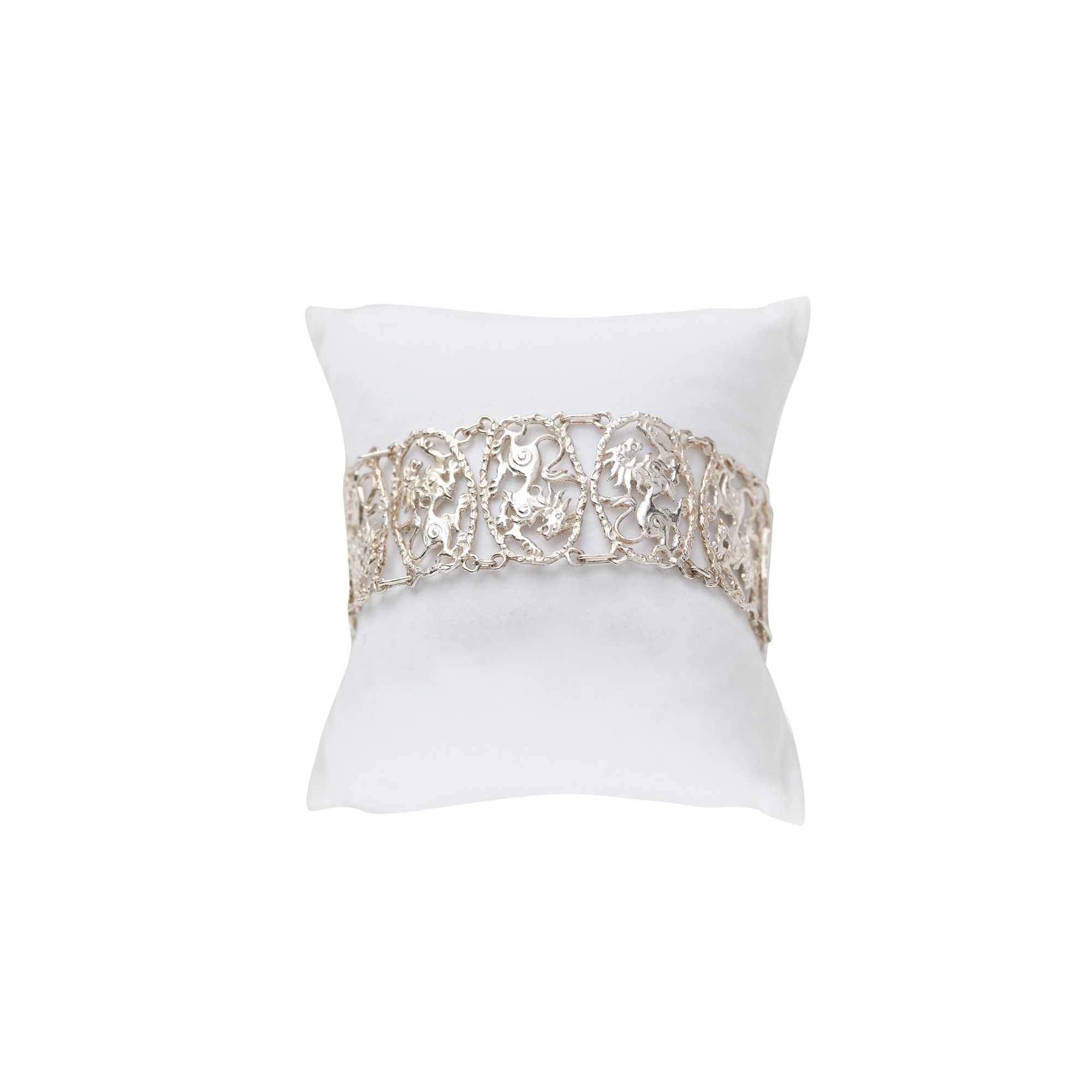 Sterling silver panel bracelet with intricate openwork detailing, flowing ornamental motifs, and handcrafted mythological-inspired design.
