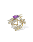 Gold and silver ring with a purple gemstone on a white background