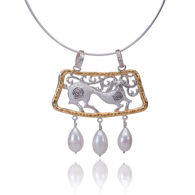 Sterling silver stag necklace with gold-plated details, ornamental openwork design, and hanging pearl drops inspired by folklore symbolism.