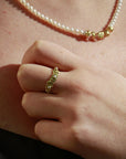 Beautiful floral ring with pearls on model's hand