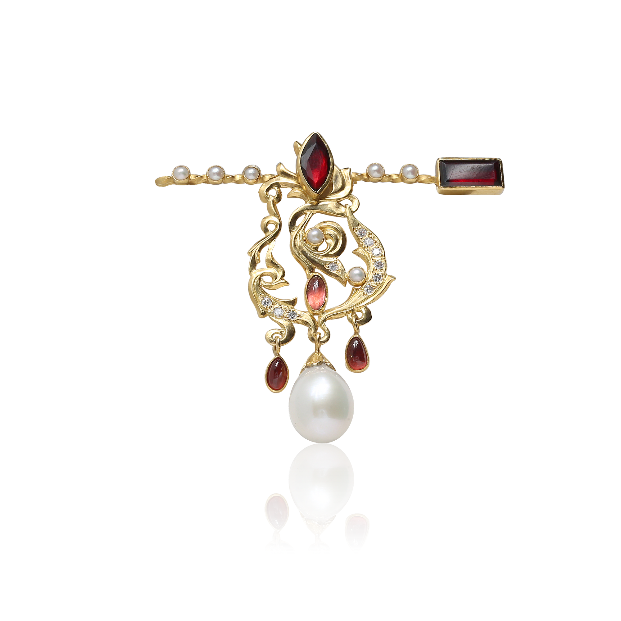 Gold brooch with pearls and garnets on a white background