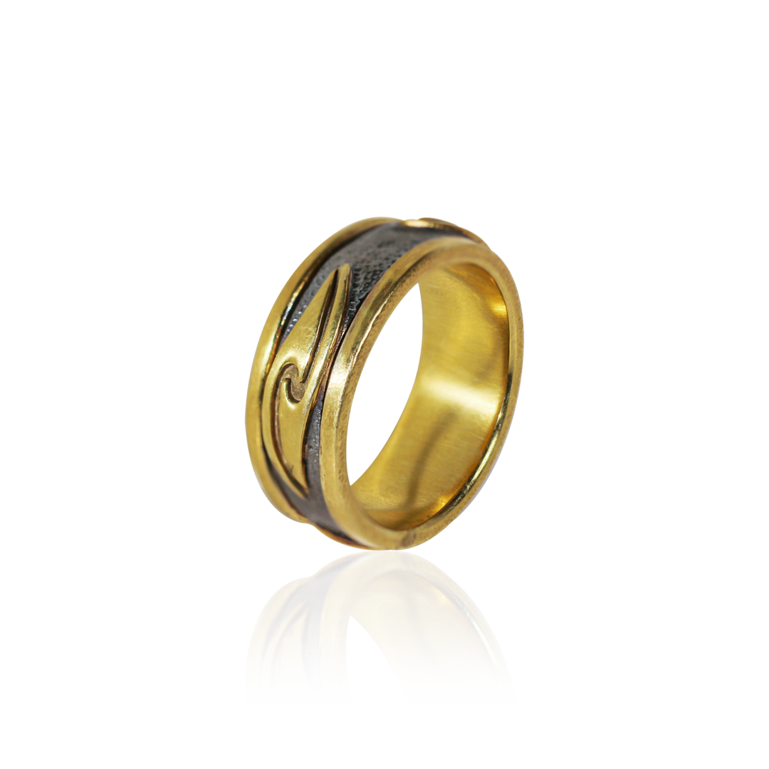 Gold ring with a reflective surface on a white background
