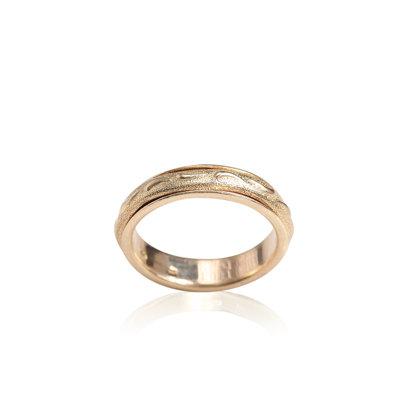 Gold ring with a textured band on a white background