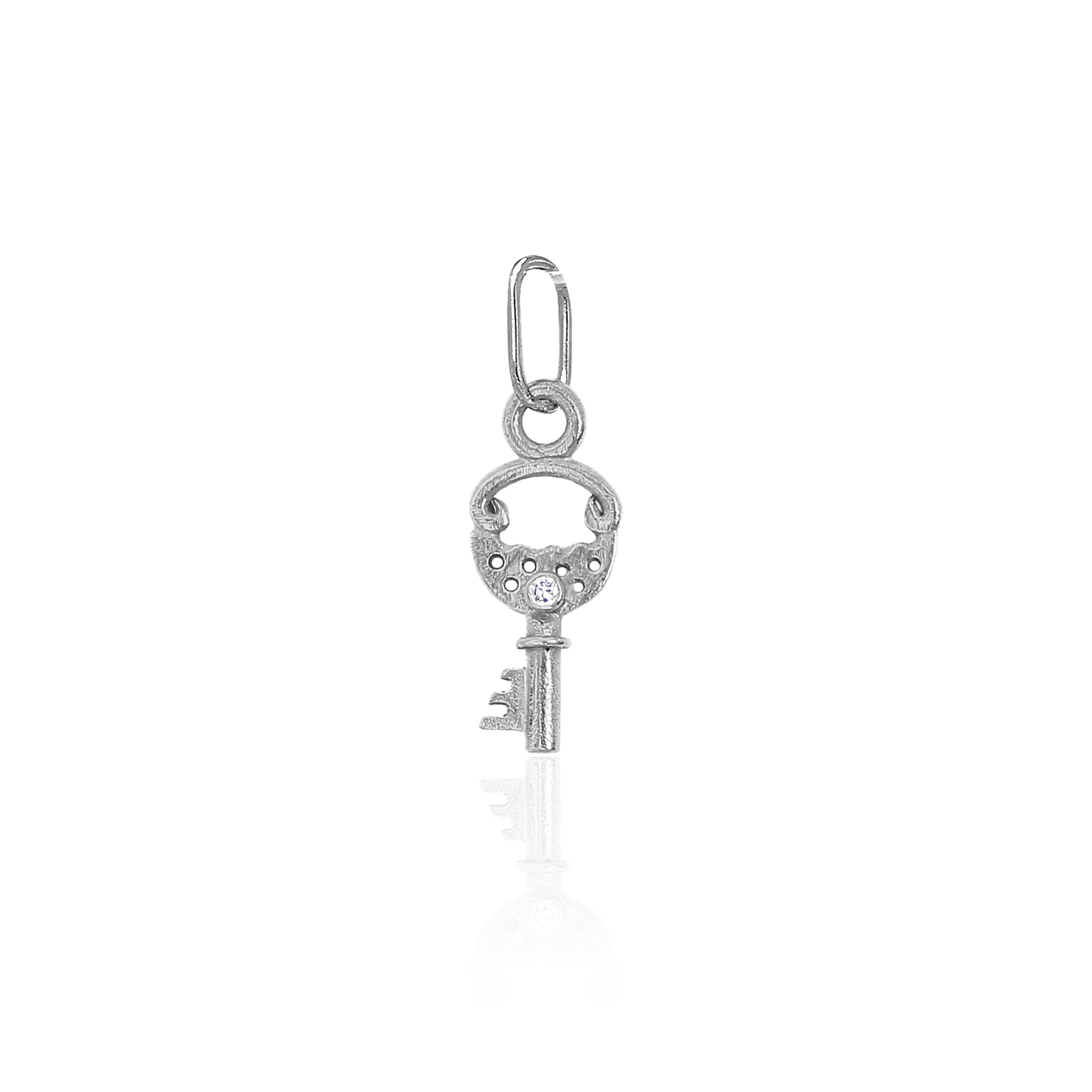 white gold and diamond pendant in the shape of a key