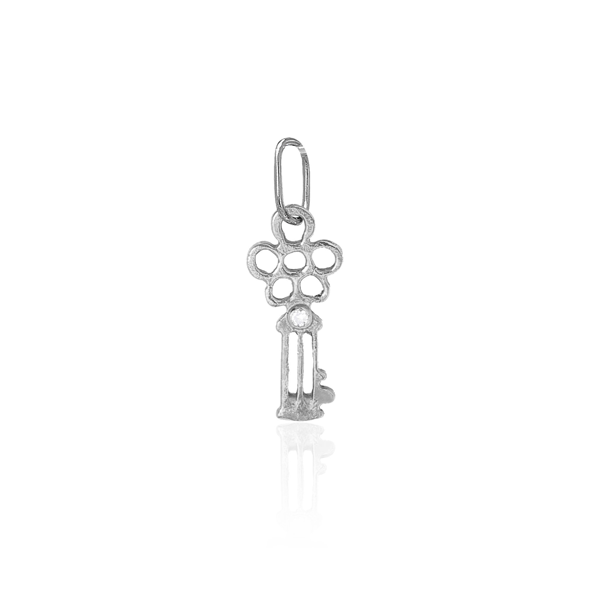 White gold key shaped pendant on a white background